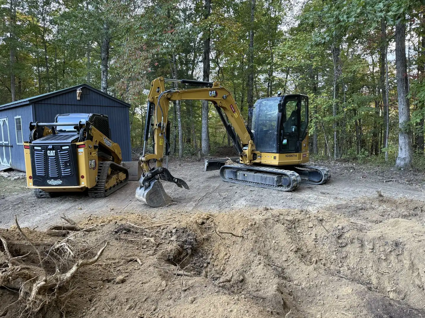 Crew using heavy equipment to perform grading on a residential site